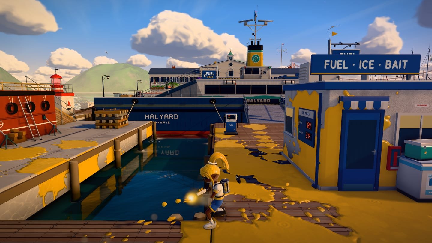Escena real de LUM INK: los equipos oro y violeta pintan una plaza frente al mar al atardecer